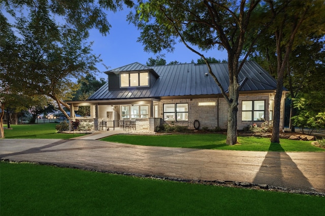 1814 Stacy Rd, Fairview, TX 75069 - back of house with a porch, stone siding, a yard, and metal roof