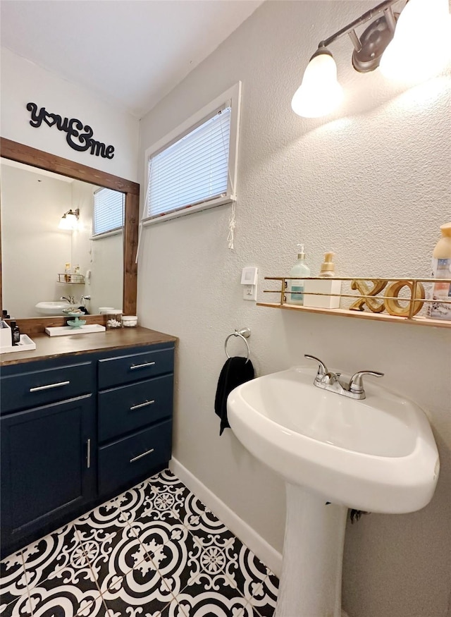 4098 Avondale St, Abilene, TX 79605 - bathroom with baseboards, a sink, and tile patterned floors