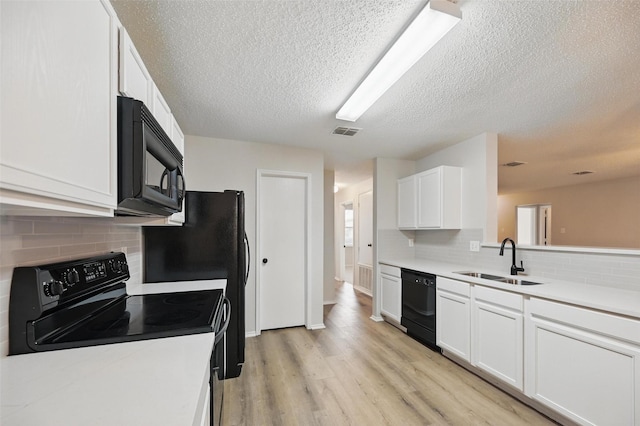 2922 Sheridan Ln, Wylie, TX 75098 - kitchen featuring black appliances, a sink, backsplash, white cabinetry, and a textured ceiling