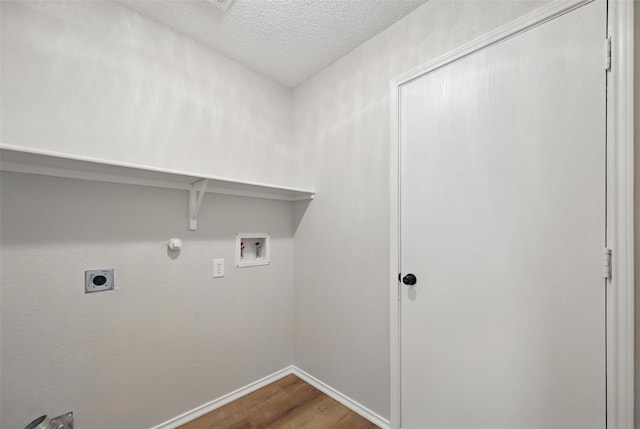 2922 Sheridan Ln, Wylie, TX 75098 - washroom with wood finished floors, hookup for a washing machine, electric dryer hookup, baseboards, and gas dryer hookup