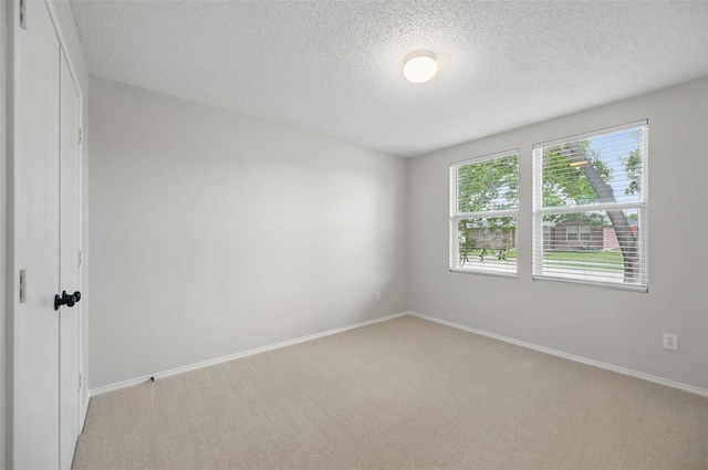 2922 Sheridan Ln, Wylie, TX 75098 - unfurnished room with light colored carpet, a textured ceiling, and baseboards