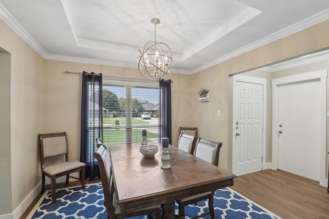 9 Chimney Rock Dr, Trophy Club, TX 76262 - dining area with a tray ceiling, a chandelier, wood finished floors, and ornamental molding