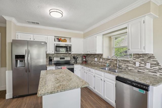 9 Chimney Rock Dr, Trophy Club, TX 76262 - kitchen featuring stainless steel appliances, a sink, ornamental molding, dark wood-style flooring, and a center island