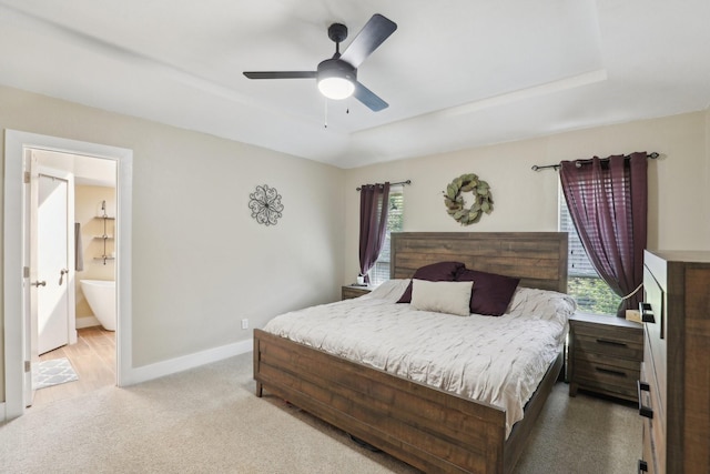 9 Chimney Rock Dr, Trophy Club, TX 76262 - bedroom featuring multiple windows, light carpet, baseboards, and a tray ceiling