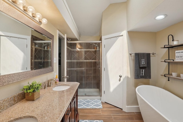 9 Chimney Rock Dr, Trophy Club, TX 76262 - bathroom featuring double vanity, a shower stall, a freestanding bath, and wood finished floors