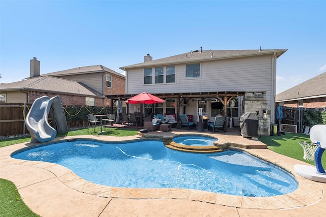 225 Redhead Dr, Little Elm, TX 75068 - view of swimming pool featuring a water slide, a patio, and a fenced backyard