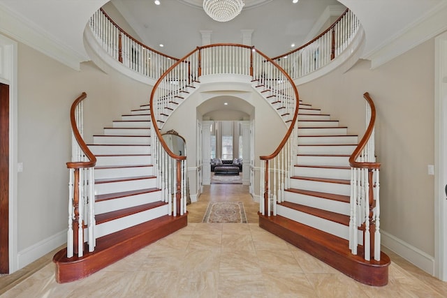 6260 Oak Hollow Dr, Burleson, TX 76028 - stairway with a towering ceiling, crown molding, recessed lighting, arched walkways, and a chandelier