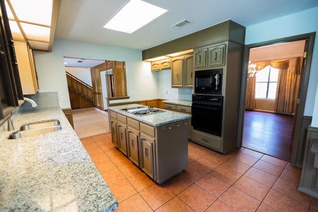 6837 Roberts Ln, Fort Worth, TX 76140 - kitchen featuring black appliances, light tile patterned floors, light stone countertops, and a kitchen island