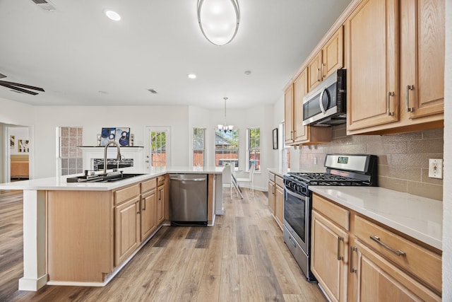 8901 Elbe Trl, Fort Worth, TX 76118 - kitchen featuring appliances with stainless steel finishes, a sink, light wood finished floors, a chandelier, and recessed lighting