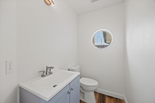 8901 Elbe Trl, Fort Worth, TX 76118 - bathroom with wood finished floors, vanity, toilet, and baseboards