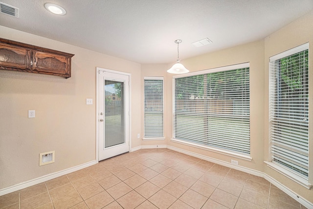 600 Swift Current Dr, Crowley, TX 76036 - unfurnished dining area featuring light tile patterned floors, healthy amount of natural light, and baseboards