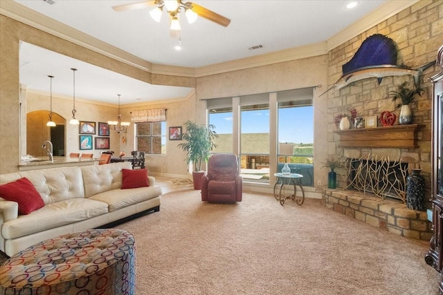 120 Trail Rdg, Weatherford, TX 76087 - living room featuring carpet flooring, ceiling fan, a chandelier, ornamental molding, and a stone fireplace