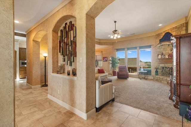 120 Trail Rdg, Weatherford, TX 76087 - living room featuring arched walkways, crown molding, ceiling fan, carpet, and a textured wall