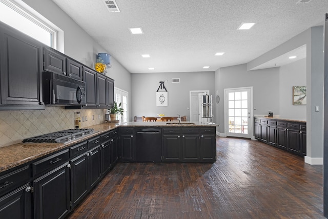 2304 Colleen Ct, Carrollton, TX 75007 - kitchen featuring black microwave, dishwasher, stainless steel gas stovetop, dark wood-style floors, and a textured ceiling