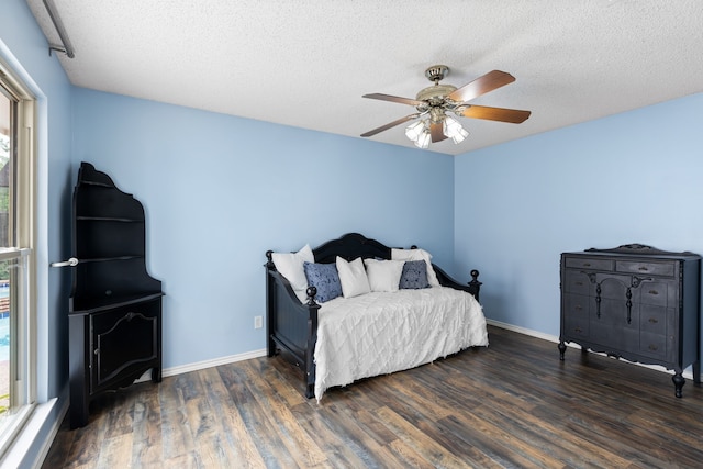 2304 Colleen Ct, Carrollton, TX 75007 - bedroom featuring multiple windows, wood finished floors, a textured ceiling, and a ceiling fan