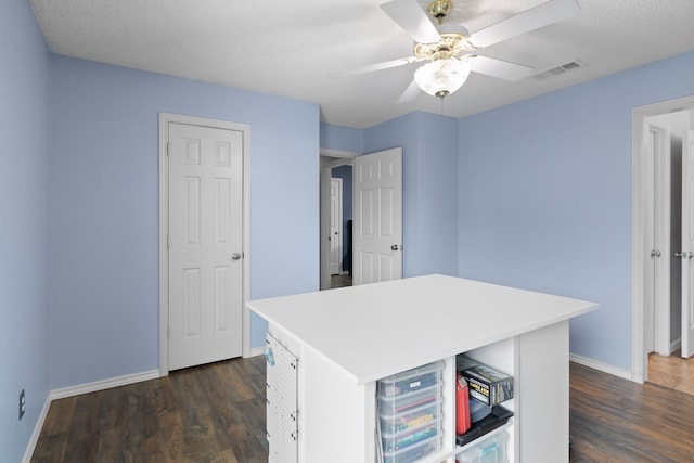 2304 Colleen Ct, Carrollton, TX 75007 - kitchen with ceiling fan, dark wood finished floors, a center island, and light countertops