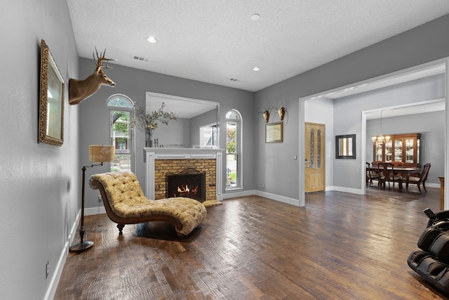 2304 Colleen Ct, Carrollton, TX 75007 - living area with wood finished floors, a textured ceiling, recessed lighting, a chandelier, and a fireplace