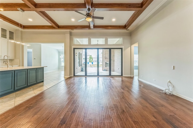 608 Amherst Dr, Rockwall, TX 75087 - unfurnished living room with a ceiling fan, coffered ceiling, light wood-type flooring, beam ceiling, and ornamental molding