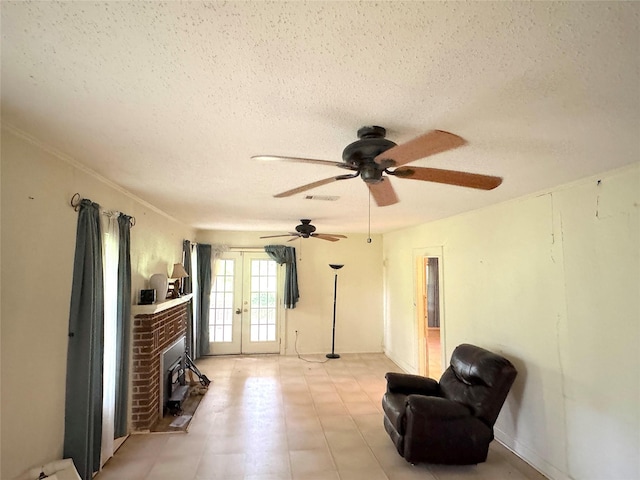 202 Powell Rd, Weatherford, TX 76088 - living area with french doors, a textured ceiling, ceiling fan, and a fireplace