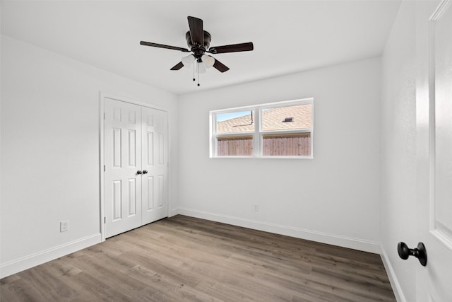 11832 Cromwell Dr, Dallas, TX 75234 - unfurnished bedroom with baseboards, wood finished floors, a closet, and ceiling fan