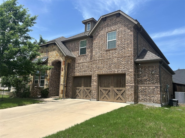 1308 Carlet Dr, Little Elm, TX 75068 - view of front of house featuring brick siding, a garage, concrete driveway, and a front yard