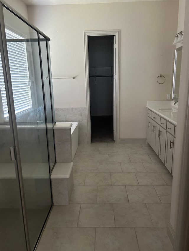 1308 Carlet Dr, Little Elm, TX 75068 - bathroom with vanity, a stall shower, a garden tub, and a walk in closet