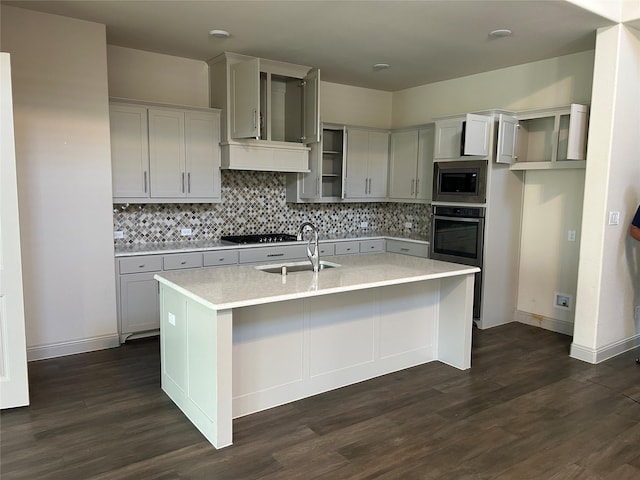1308 Carlet Dr, Little Elm, TX 75068 - kitchen featuring appliances with stainless steel finishes, a sink, dark wood-type flooring, and tasteful backsplash