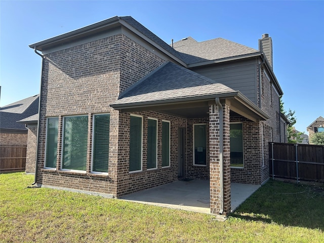 1308 Carlet Dr, Little Elm, TX 75068 - back of property featuring brick siding, a patio, a chimney, and roof with shingles