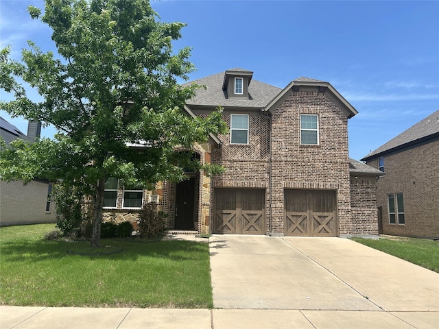 1308 Carlet Dr, Little Elm, TX 75068 - view of front of property featuring brick siding, a garage, a front yard, driveway, and a shingled roof