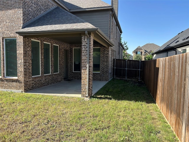 1308 Carlet Dr, Little Elm, TX 75068 - back of property with brick siding, a shingled roof, a patio area, and a chimney