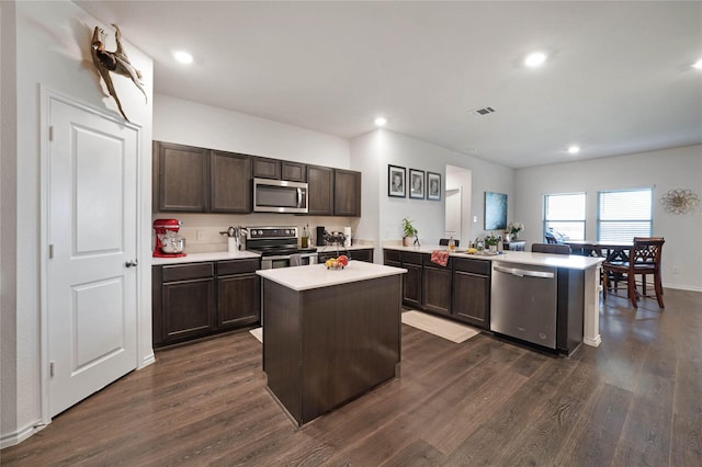 2212 Rosemary Way, Anna, TX 75409 - kitchen with stainless steel appliances, light countertops, dark wood-type flooring, a peninsula, and dark brown cabinets