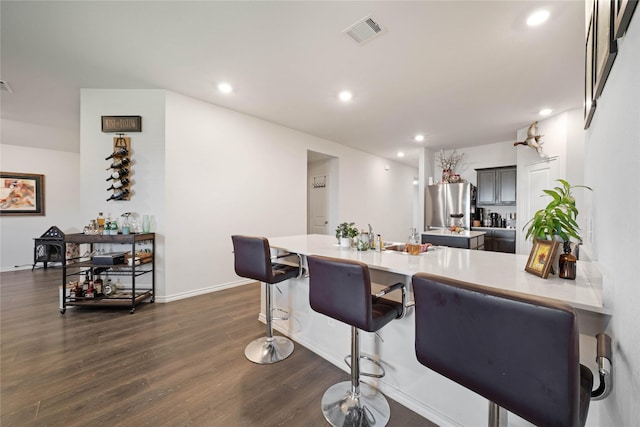 2212 Rosemary Way, Anna, TX 75409 - kitchen featuring stainless steel fridge with ice dispenser, light countertops, dark wood-type flooring, a breakfast bar area, and recessed lighting