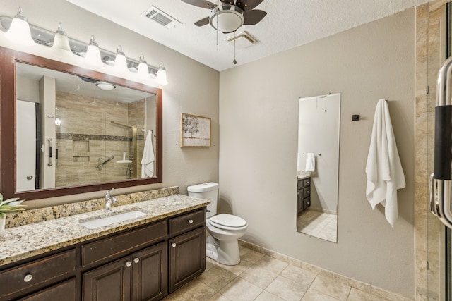 3233 Princess St, Bedford, TX 76021 - full bath with vanity, ceiling fan, toilet, a shower stall, and tile patterned flooring
