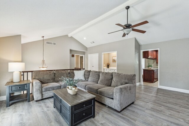 3233 Princess St, Bedford, TX 76021 - living area featuring a ceiling fan, light wood-type flooring, baseboards, beamed ceiling, and high vaulted ceiling