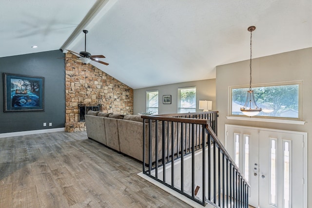3233 Princess St, Bedford, TX 76021 - living room with ceiling fan, wood finished floors, and a stone fireplace