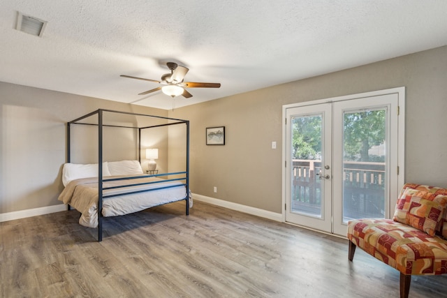 3233 Princess St, Bedford, TX 76021 - bedroom with access to outside, wood finished floors, a textured ceiling, baseboards, and ceiling fan