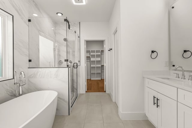 908 Muncie Ave, Dallas, TX 75212 - full bath featuring a marble finish shower, a freestanding tub, vanity, and a walk in closet