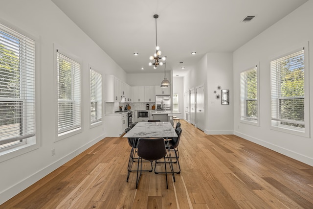 908 Muncie Ave, Dallas, TX 75212 - dining area featuring healthy amount of natural light, baseboards, light wood-style flooring, a chandelier, and recessed lighting