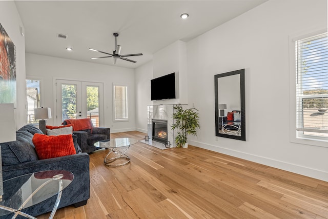 908 Muncie Ave, Dallas, TX 75212 - living room featuring a fireplace with flush hearth, french doors, a ceiling fan, light wood finished floors, and recessed lighting