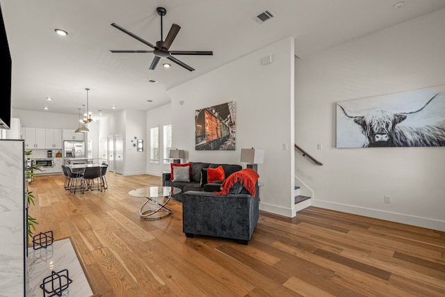 908 Muncie Ave, Dallas, TX 75212 - living room featuring light wood-style flooring, a ceiling fan, baseboards, recessed lighting, and stairs