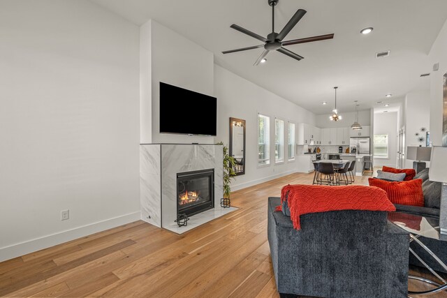 908 Muncie Ave, Dallas, TX 75212 - living room featuring a tile fireplace, a ceiling fan, light wood-style floors, recessed lighting, and baseboards