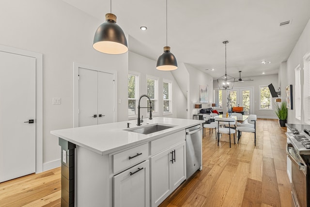 920 Muncie Ave, Dallas, TX 75212 - kitchen with a sink, stainless steel appliances, light wood-type flooring, open floor plan, and light countertops