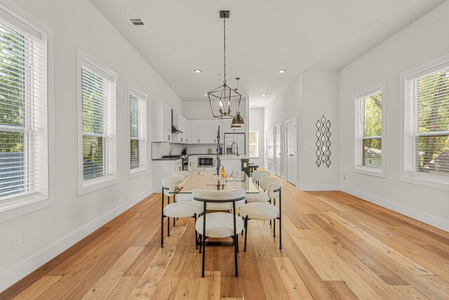 920 Muncie Ave, Dallas, TX 75212 - dining room with baseboards, a chandelier, light wood finished floors, and recessed lighting