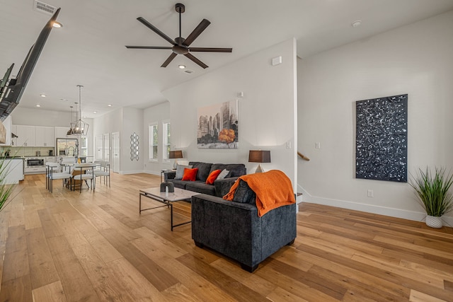920 Muncie Ave, Dallas, TX 75212 - living area featuring ceiling fan, light wood-style floors, baseboards, recessed lighting, and stairs