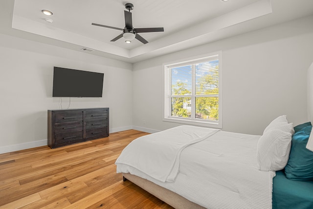 920 Muncie Ave, Dallas, TX 75212 - bedroom featuring a tray ceiling, baseboards, wood finished floors, recessed lighting, and a ceiling fan