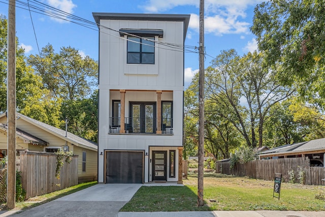 920 Muncie Ave, Dallas, TX 75212 - contemporary home featuring a balcony, board and batten siding, concrete driveway, and a garage