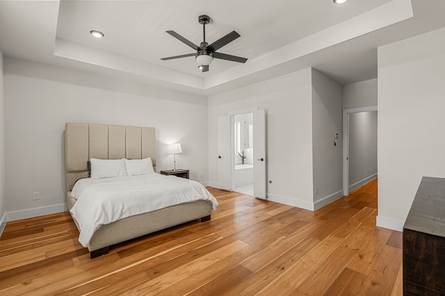 920 Muncie Ave, Dallas, TX 75212 - bedroom featuring a raised ceiling, light wood-style flooring, recessed lighting, baseboards, and ensuite bathroom
