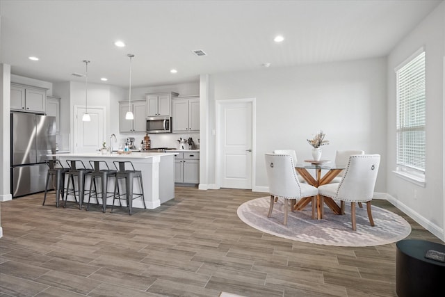 517 Big Horn Pass, Denton, TX 76210 - dining area with wood finished floors, recessed lighting, and baseboards