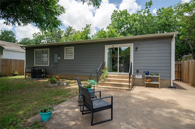 1306 S Oak Cliff Blvd, Dallas, TX 75208 - back of property featuring entry steps, cooling unit, and a patio area