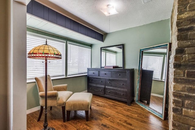 677 Fm 3356, Van Alstyne, TX 75495 - living area featuring wood finished floors, baseboards, and a textured ceiling